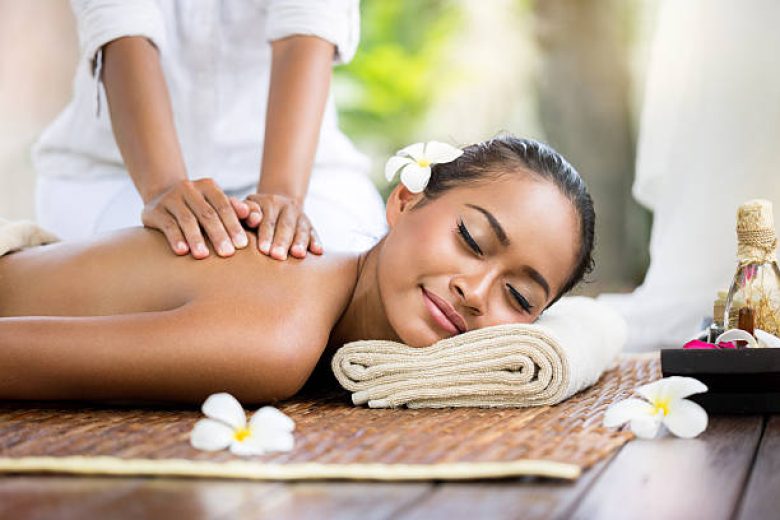 Spa massage outdoor, Balinese woman receiving back massage